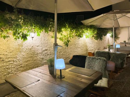 a table with an umbrella and some chairs and a table sidx sidx at Harzhotel Warnstedter Krug in Thale