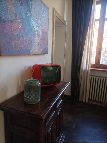 a television sitting on top of a wooden table at Palazzo 1831 in Nizza Monferrato