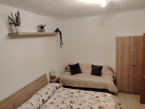 a bedroom with a bed and a couch in it at Il Terra Cielo Apartment in Modugno
