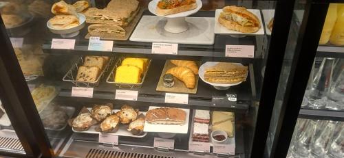 a display case filled with different types of sandwiches at Dhanolti Village Resort Dhanaulti in Dhanaulti