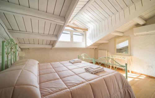 a bedroom with a large bed in an attic at Dimora Di Famiglia in Belmonte Mezzagno