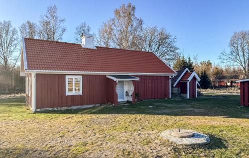 a red barn with a red roof on a field at 2 Bedroom Nice Home In Bredaryd in Bredaryd