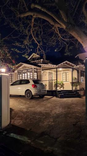 a car parked in front of a house at night at Rococo by Concordia Hospitality in Shillong
