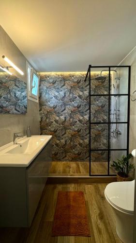 a bathroom with a tub and a sink and a shower at Garden House Flogita in Flogita