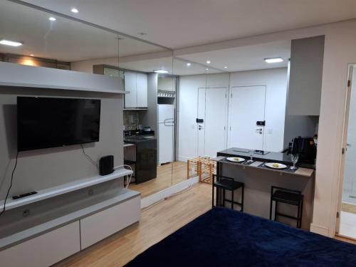 a large living room with a large flat screen tv at Studio premium próximo a Alphaville in Barueri