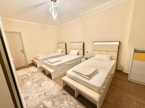 a room with three beds in a room at Luxury Apartment in Down Town - New Alamein in El Alamein