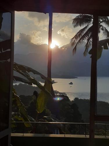 a view of the ocean from a room with a window at Green nature inn villa in Digana