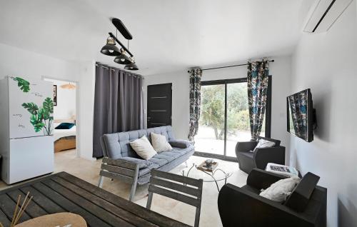 un salon avec un canapé bleu et des chaises dans l'établissement Lovely Home In Saint-Bauzille-De-Mont, à Buzignargues