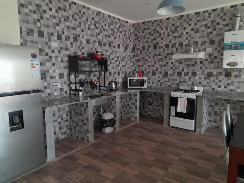 a kitchen with a refrigerator and a counter top at Lo de Moni in San Ramón de la Nueva Orán