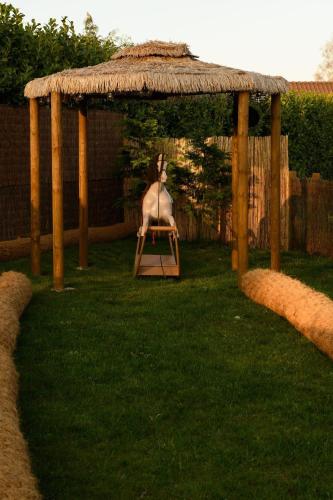 a goat sitting in a chair in a gazebo at Bespoke Holiday Home With Private Pool And Hot Tub, Sleeps 8 Ref 34073P in Kings Lynn