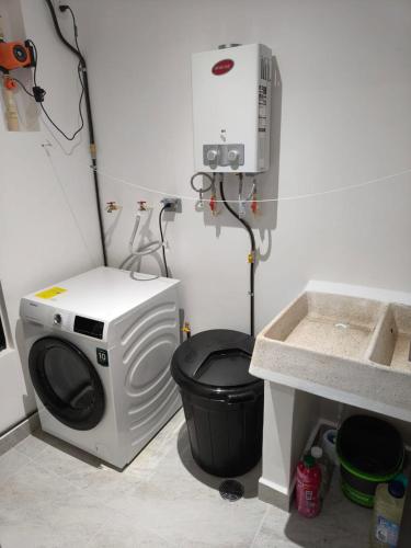 a washing machine in a bathroom with a sink at Casa Bambú, apartment in the best part of Playa del Carmen in Playa del Carmen