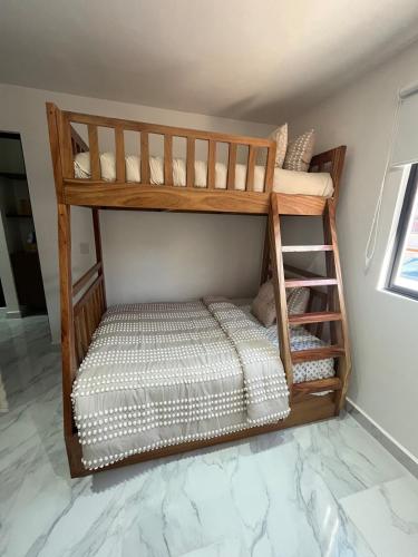 a wooden bunk bed in a room at Casa Bambú, apartment in the best part of Playa del Carmen in Playa del Carmen