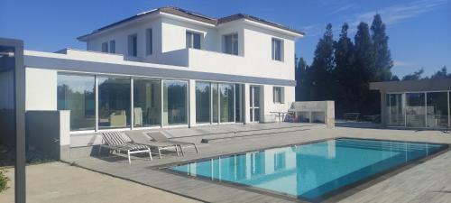 a house with a swimming pool in front of it at Kiti Village Villa, Cyprus, salt-water pool, 5 bedrooms, Larnaca in Kiti
