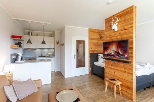 a living room with a large wooden wall at Ferienwohnung BergChalet 1 mit Balkon in Braunlage