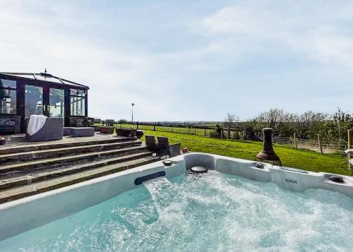a hot tub with water coming out of it at Glan Morfa Lodge Retreat in Newborough