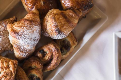 a tray of croissants and other pastries on a table at Relais Poggio Borgoni in San Casciano in Val di Pesa