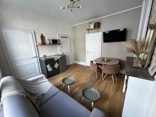 a living room with a couch and a table at Appartement Marine - Résidence La Porte Verte in Boulogne-sur-Mer