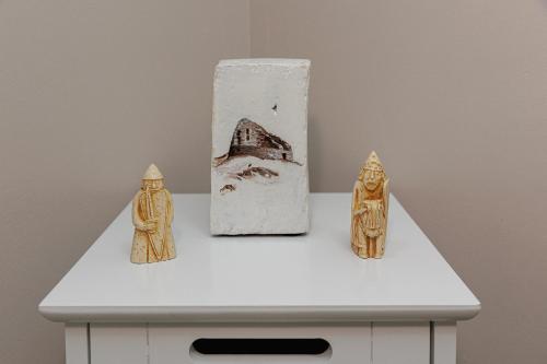 three figurines on a white table with a vase at Croft@42 in Vatsker