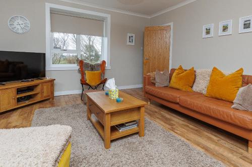 a living room with a couch and a table at Croft@42 in Vatsker