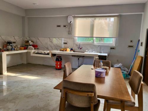 a kitchen with a table and chairs and a sink at Zimba Cottage Retreat in Kalimpong