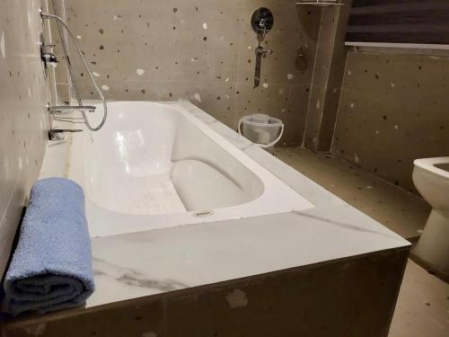 a bathroom with a bath tub and a toilet at Zimba Cottage Retreat in Kalimpong