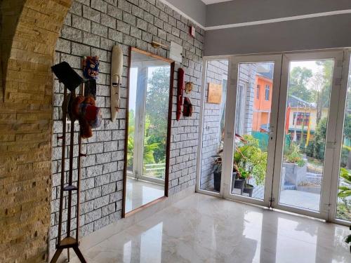 a room with a mirror and a brick wall at Zimba Cottage Retreat in Kalimpong
