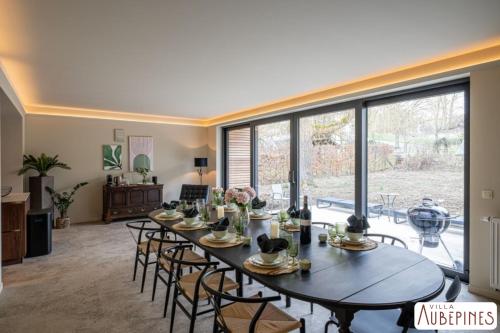 Un gran comedor con mesa y sillas. en Villa Aubépines, en Rochefort