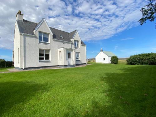 a house with a large lawn in front of it at Croft@42 in Vatsker