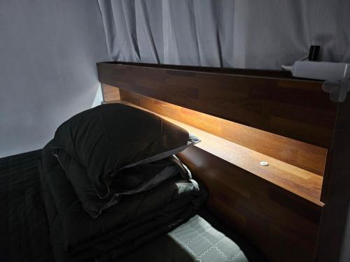 a bedroom with a bed with a wooden headboard at Stay JAYU in Daejeon