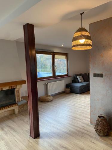 a living room with a couch and a fireplace at 160m piękny stylowy dwupoziomowy dom in Gdynia
