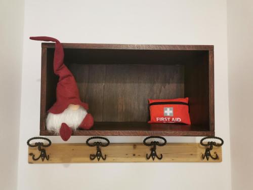 a santa claus doll sitting in a wooden box at Maso Tofolaci in Pergine Valsugana