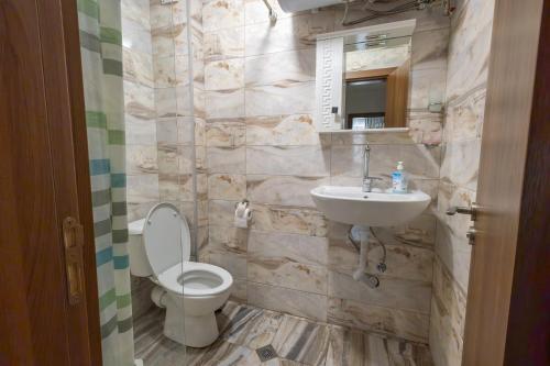 a bathroom with a toilet and a sink at Sea Garden Marina 2 in Varna City