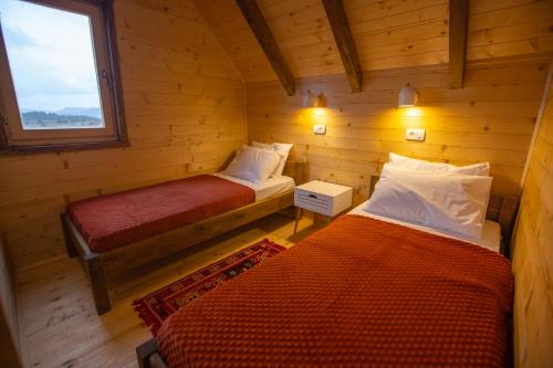 a room with two beds in a log cabin at Arhetip, Djedova Villa in Žabljak