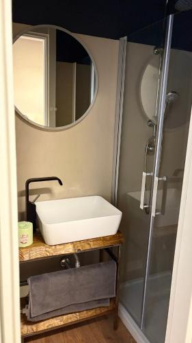 a bathroom with a sink and a mirror at LePetit in Porto Santo Stefano