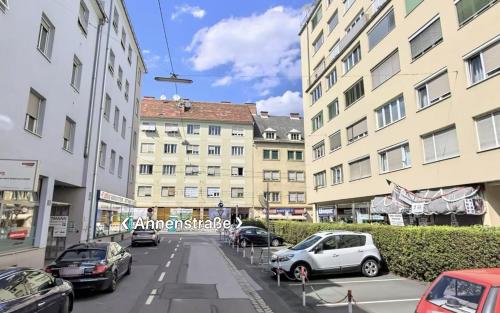 a city street with cars parked in front of buildings at Wohnung in Graz mit Klima SOVA 3 in Graz