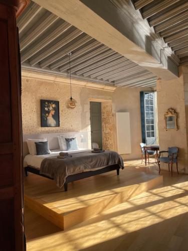 a bedroom with a large bed in a room at Chambre Isabeau de Sully au château de Meauce in Saincaize-Meauce