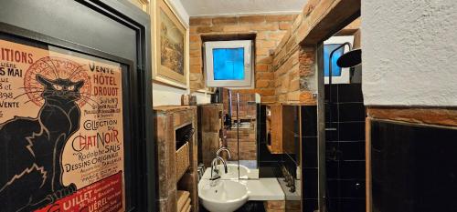 a bathroom with a cat poster and a sink at Apartment Piaf in Donja Dubrava