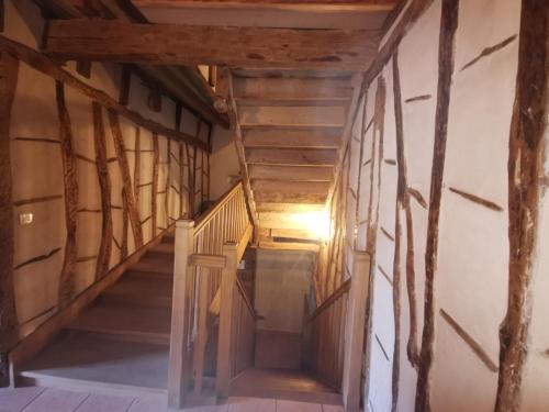 a hallway in a house with wooden stairs at La chacunière de Labarthe in Fleurance