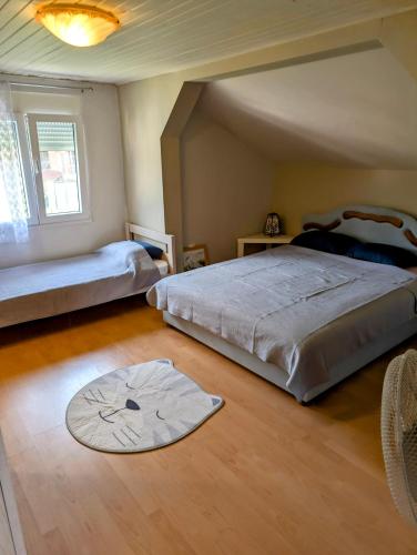 a bedroom with two beds and a rug on the floor at Sunset Dreams Utjeha in Utjeha