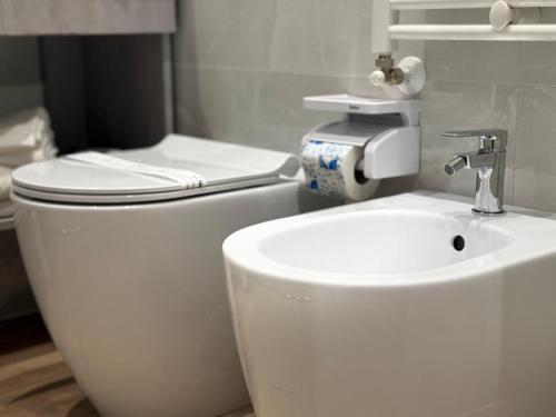 a bathroom with a white toilet and a sink at LaBienbi' in Cosenza