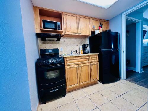 a kitchen with a black stove and a refrigerator at Updated Oceanfront Pools & More S129 in Myrtle Beach