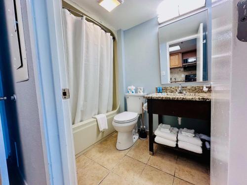 a bathroom with a toilet and a sink at Updated Oceanfront Pools & More S129 in Myrtle Beach