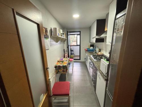 a small kitchen with a table and a counter top at Piso cercano al puerto in Denia