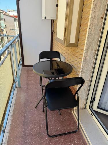 a table and two chairs on a balcony at LaBienbi' in Cosenza