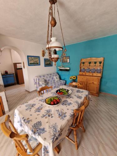 a dining room with a table with a bowl of fruit on it at La casa dei Nonni in Carloforte