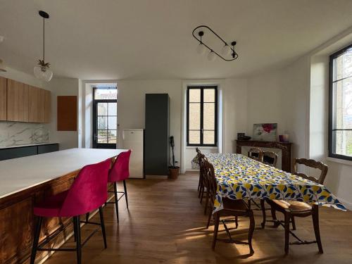 a kitchen and dining room with a table and chairs at Maison 1880 in Annonay