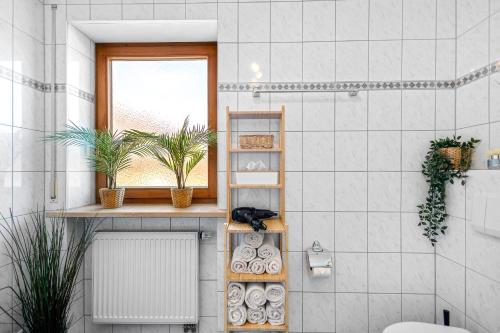 a bathroom with a toilet and a window at CASARINA - Alpentraum am Barmsee mit Garten in Krün