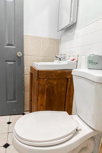 a bathroom with a white toilet and a sink at OYO Hotel Jonesboro Near Atlanta Airport in Jonesboro