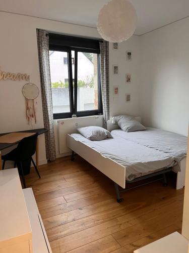 une chambre avec un lit, un bureau et une fenêtre dans l'établissement Demeure Familiale Haut de Gamme 230m2 en Centre-Ville de Nantes Tramway à 2 min, à Nantes