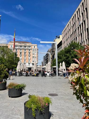 a city square with tables and umbrellas and buildings at ZaragozaHome El Tubo - Ideal Familias - Parking in Zaragoza